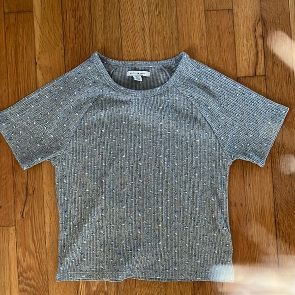 grey shirt with little blue flowers on it